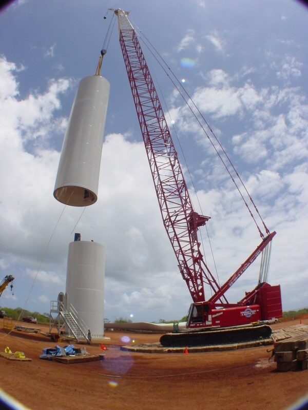 A crane lifting a large cylindrical component