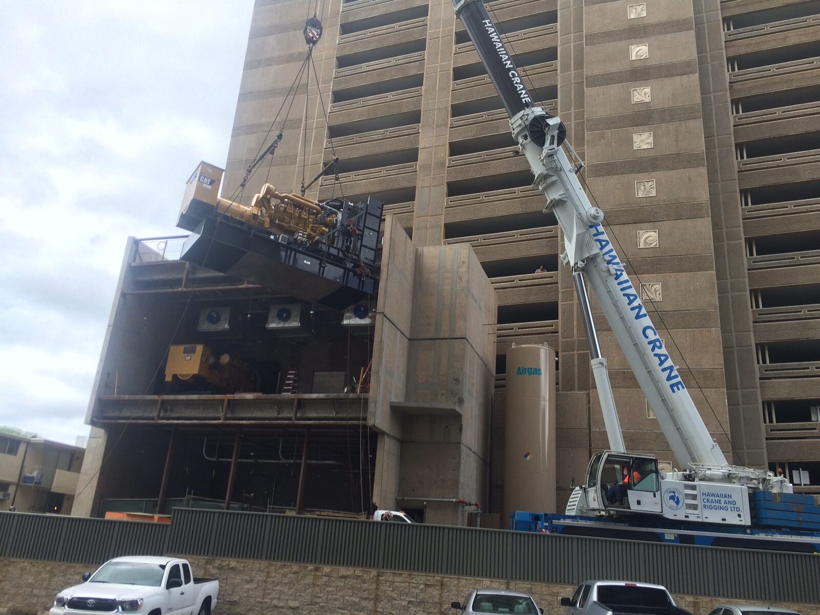 A crane working alongside a multistory building